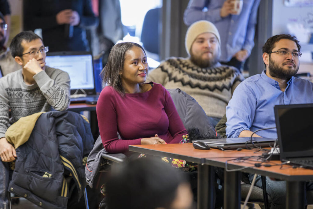 Students sitting in a classroom listening to instructor