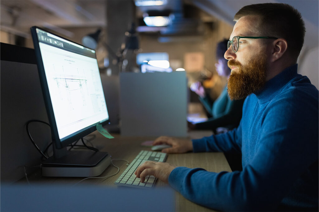 Man looking at CAD files on computer screen