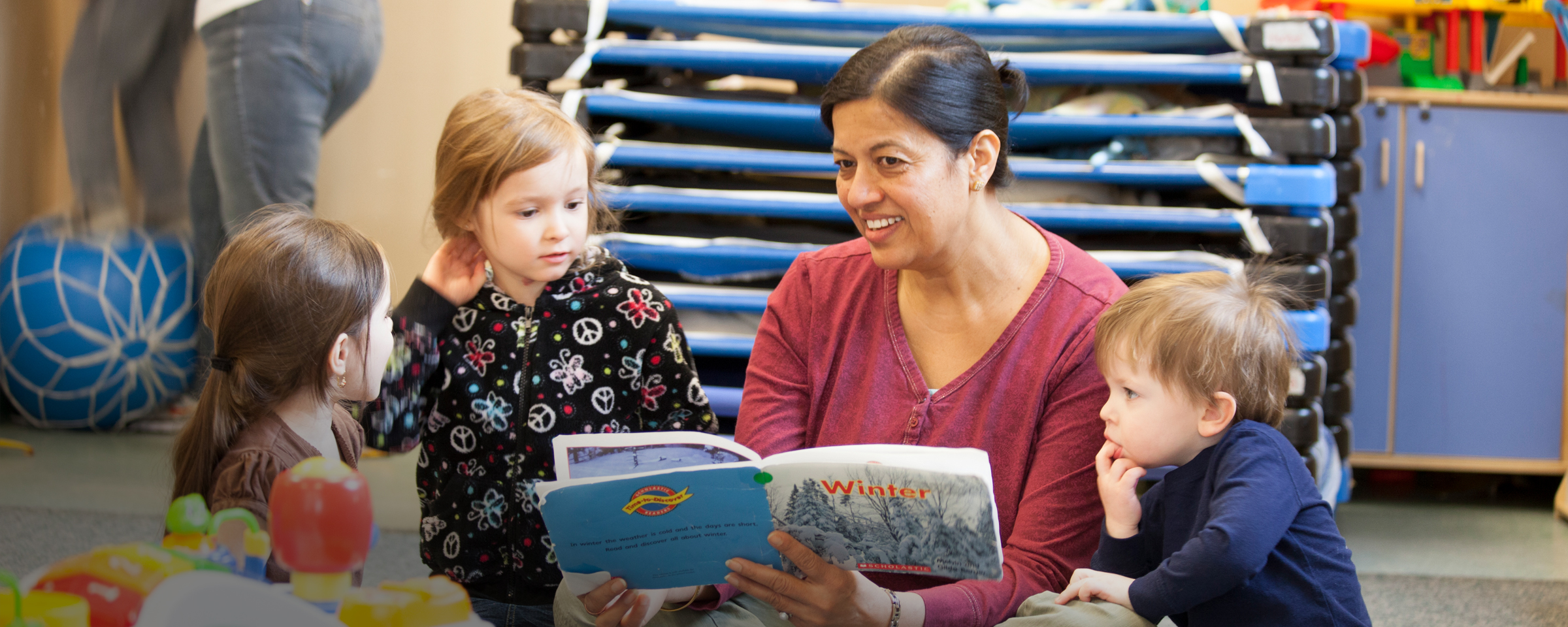 Early childhood educator reading to kids