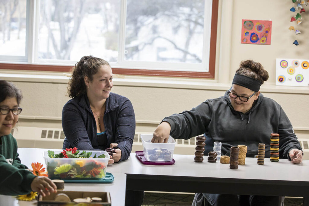 Adults building with blocks in a classroom