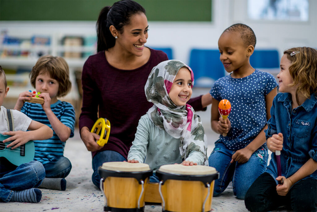 Daycare worker playing with children