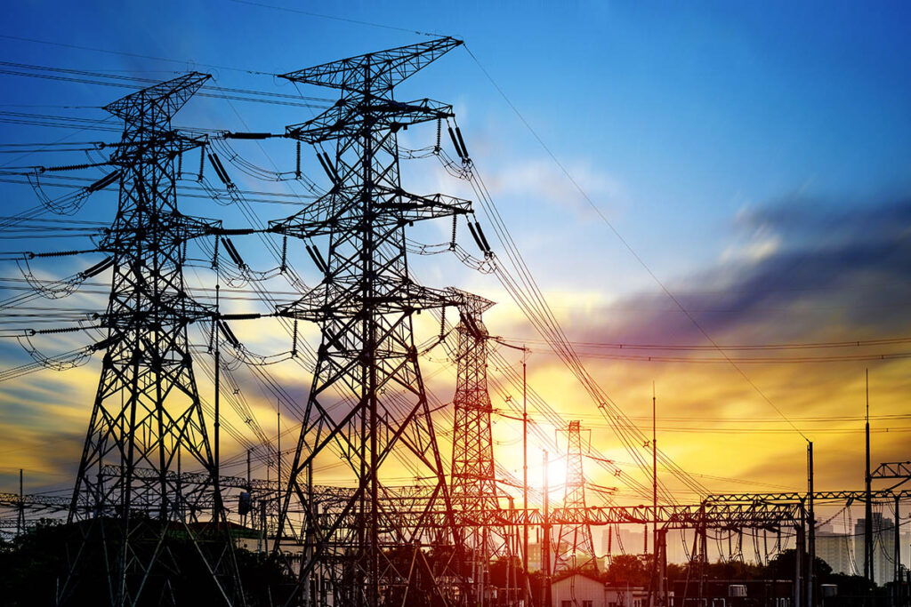 Outdoor photo of power lines at sunset