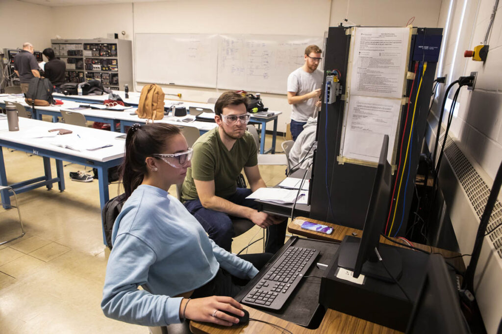 Students in a lab working on a computer