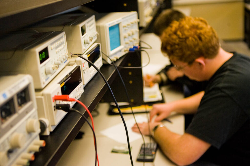 Electrical engineering student measuring voltage