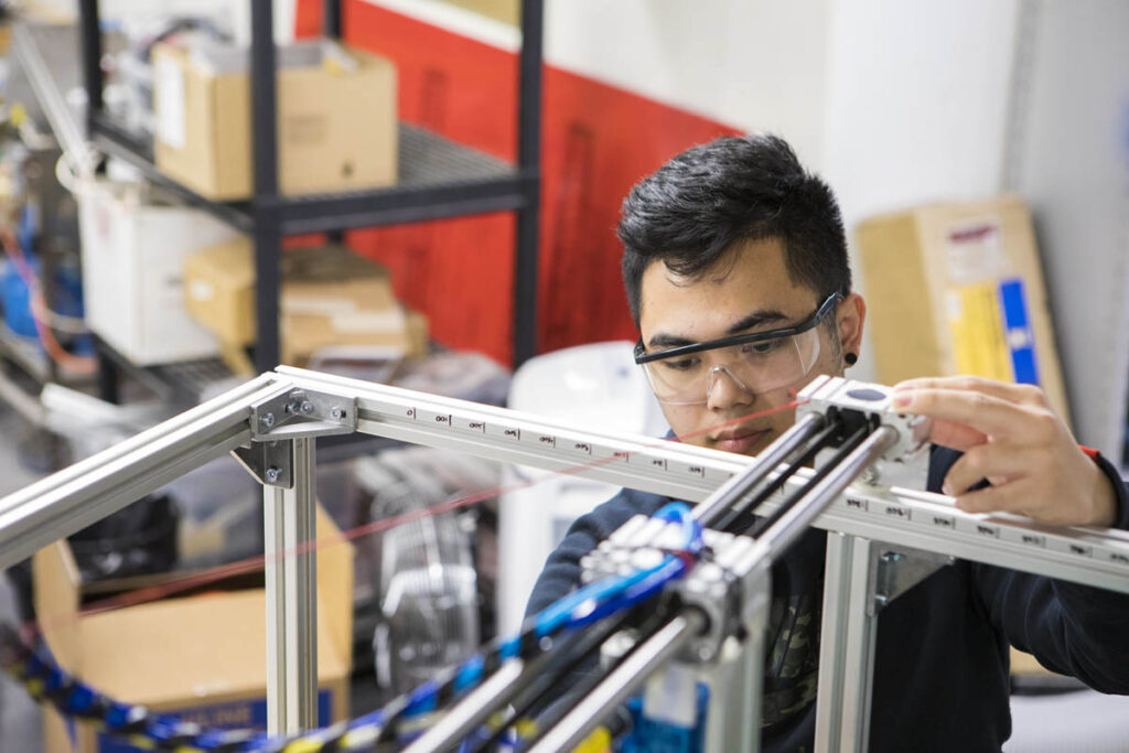 Instrumentation engineering student operating a machine in a lab