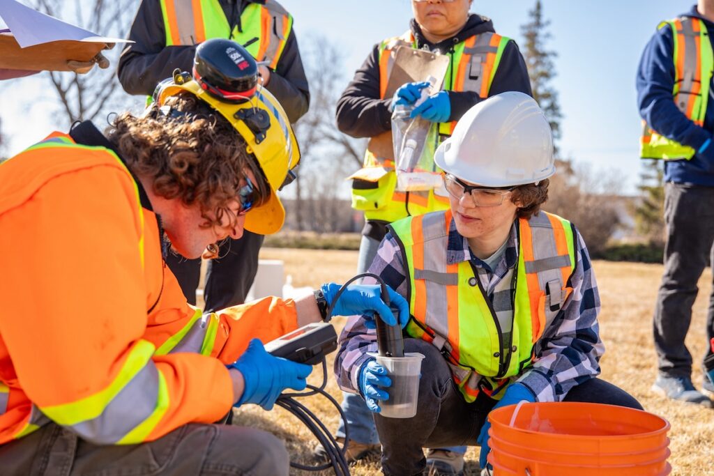 Group of students outdoors working on water quality testing