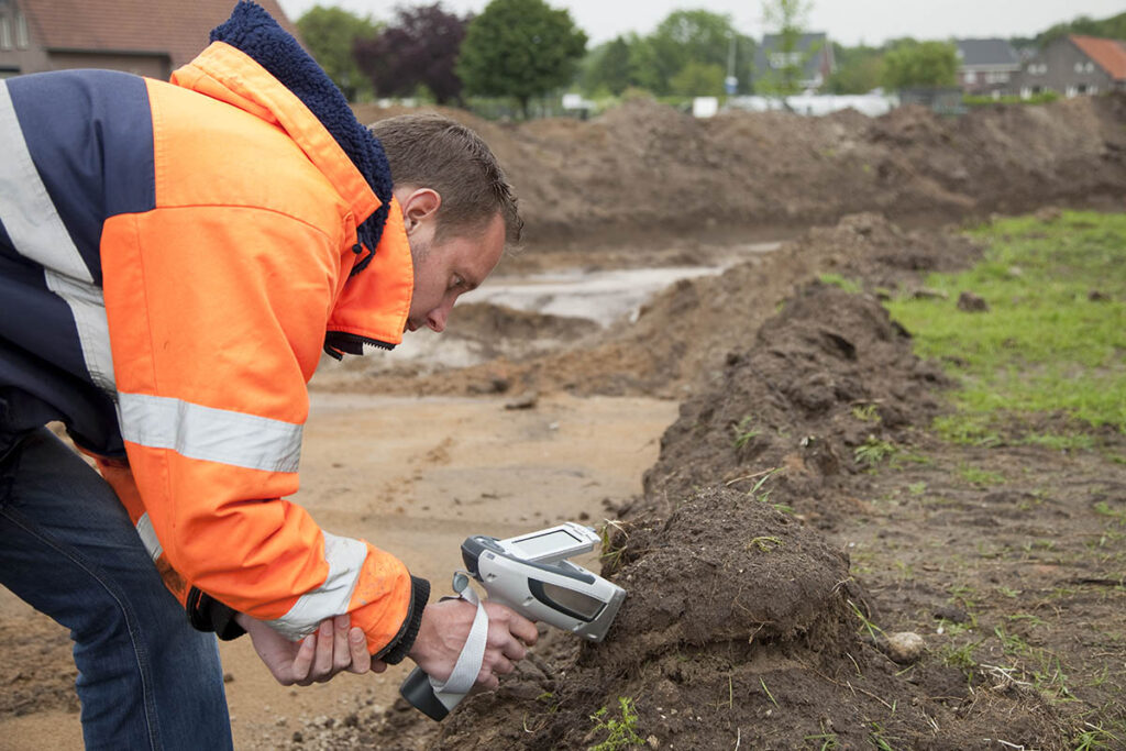 Man testing soil at construction site