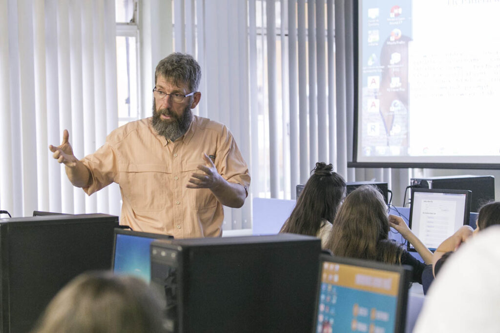 Instructor talking to class in a computer lab
