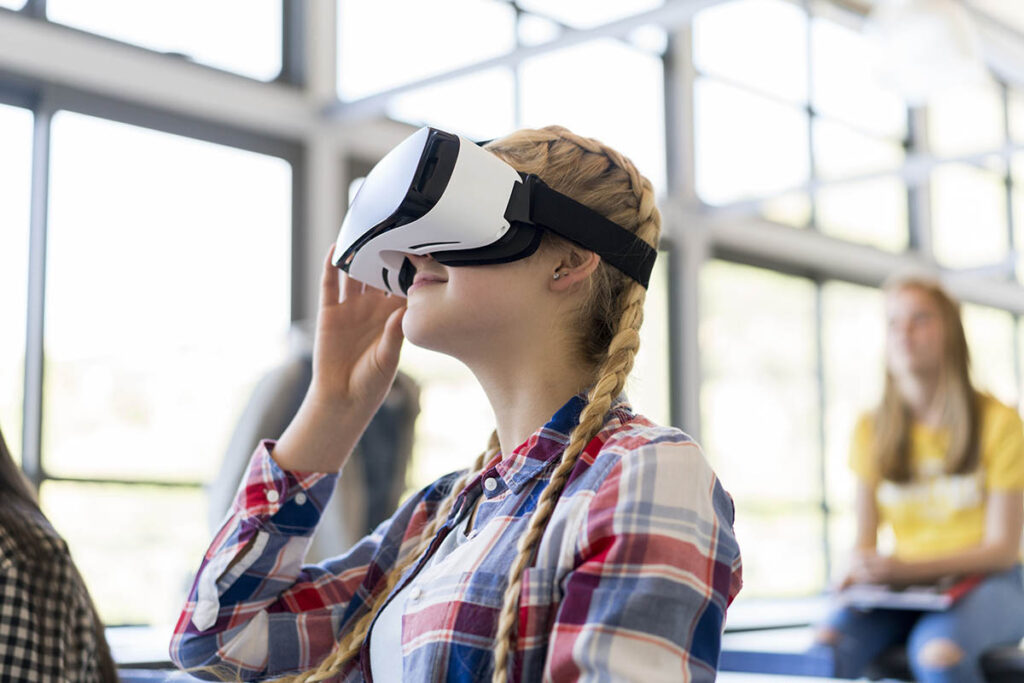 Woman in a classroom wearing a VR headset