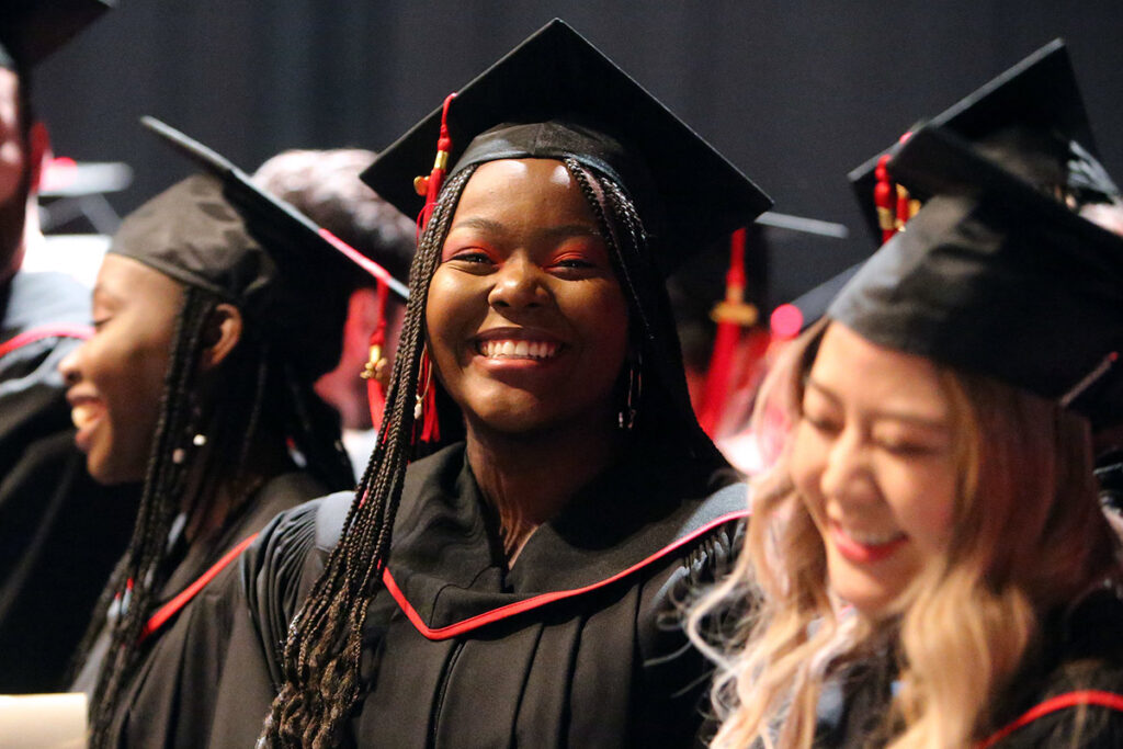 Smiling graduates wearing caps and gowns