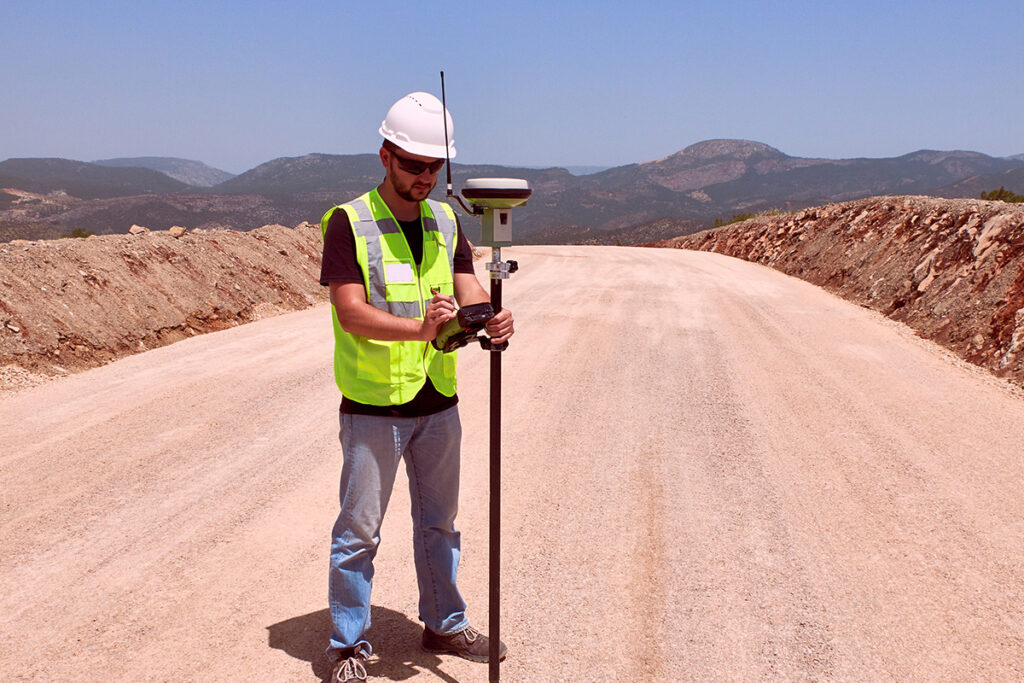 Man at a road construction site checking the level of the road