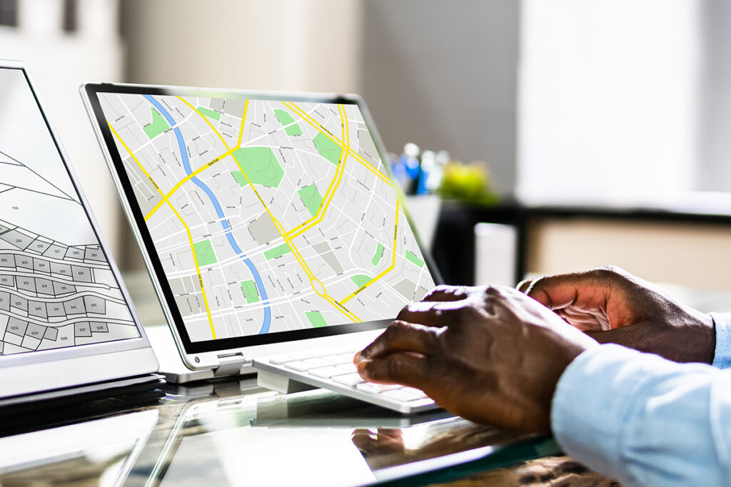 Person using a laptop displaying the map of a city