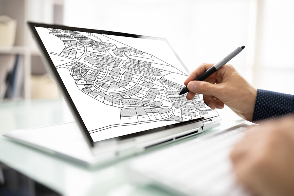 Person drawing a city map on a tablet