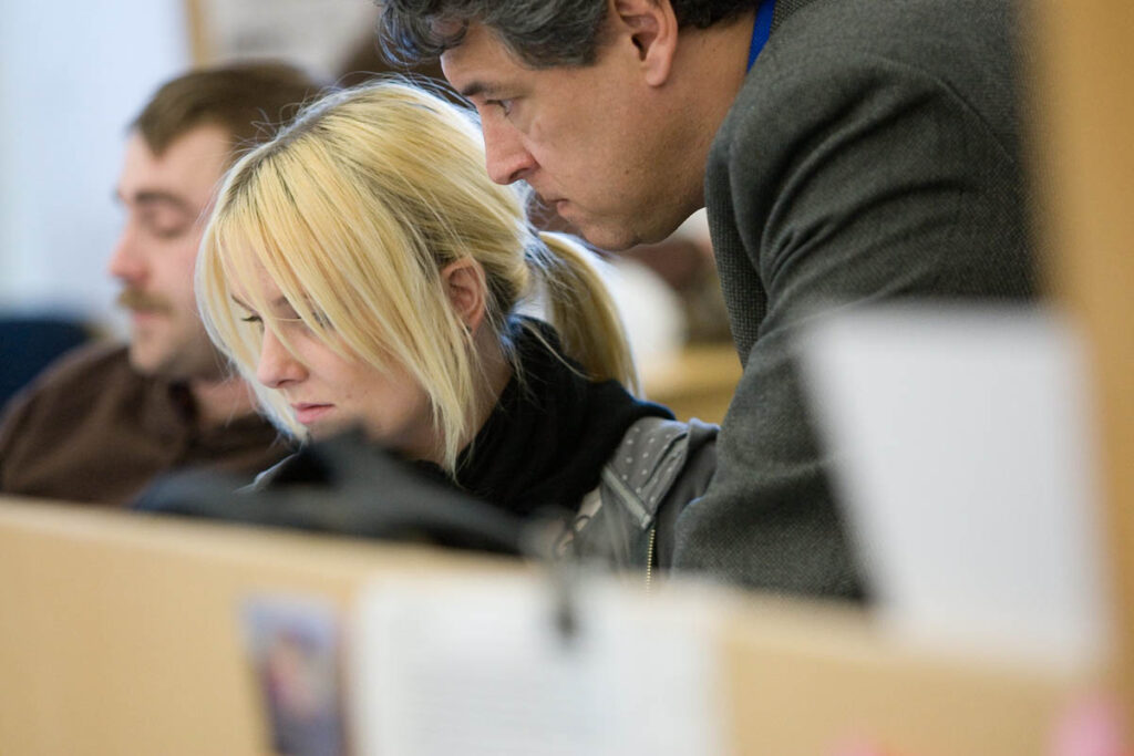 Instructor talking to student in a design lab 