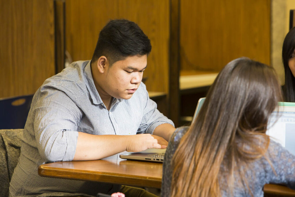 Students in a classroom working on laptops