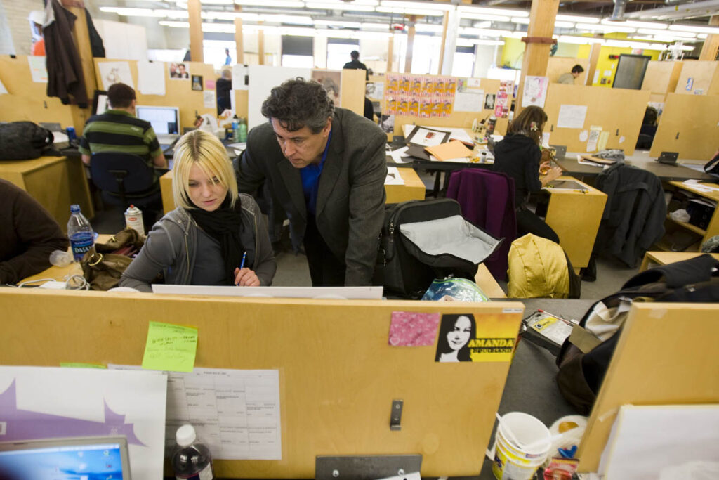 Instructor talking to student in a student design studio