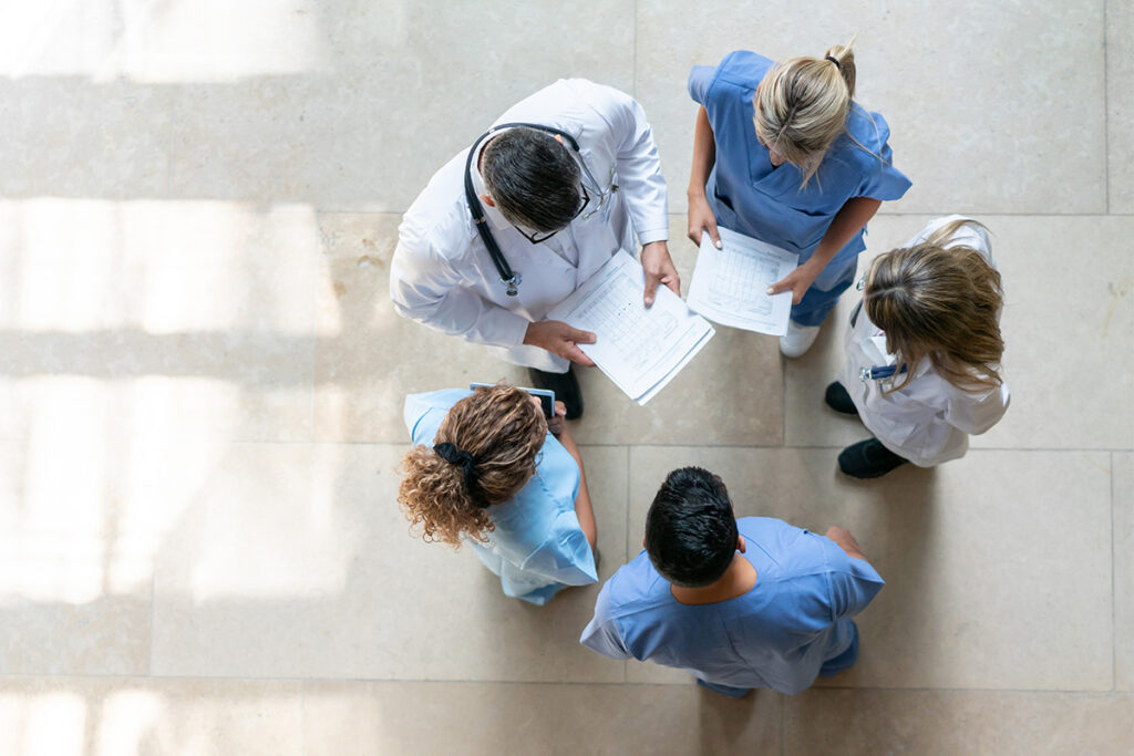 Doctors and nurses discussing patient charts