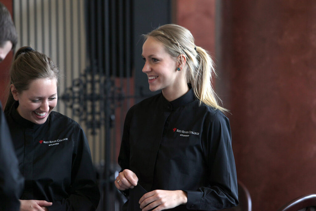 Hospitality student standing in a restaurant