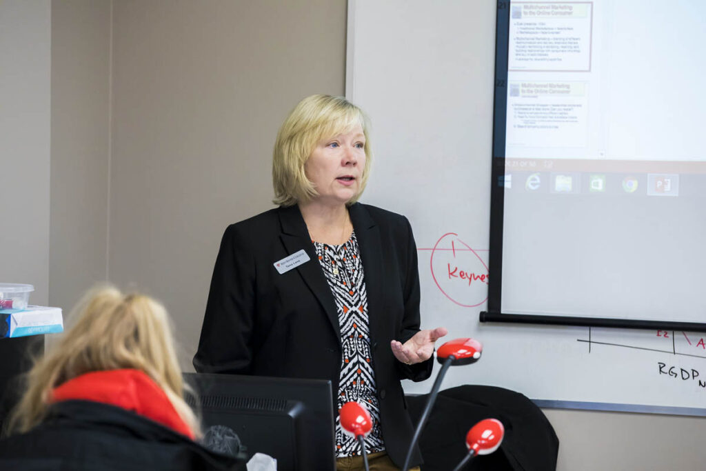 Instructor speaking to classroom of students