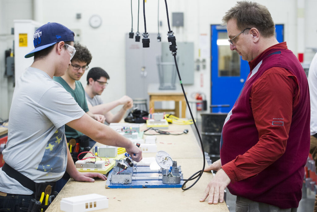 Students learning how to wire devices in a student lab