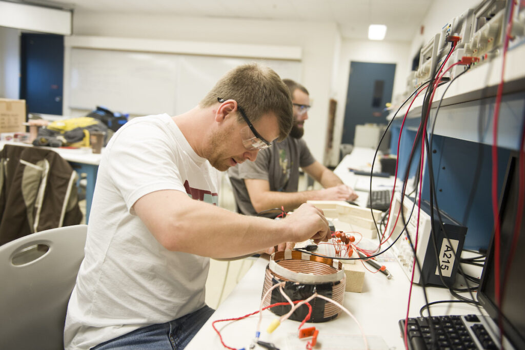 Students sitting in a lab and wiring different devices