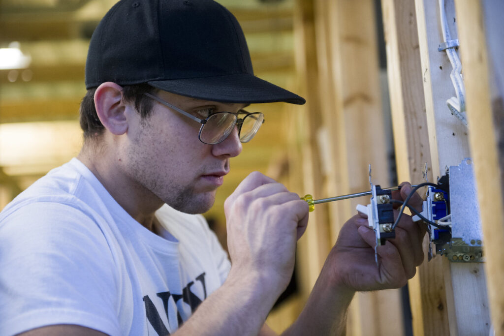 Student wiring switch at a simulated construction site