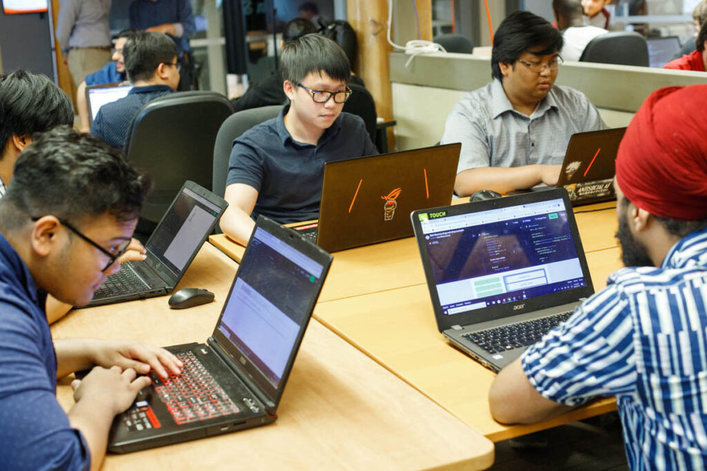 Students working on laptops in a classroom