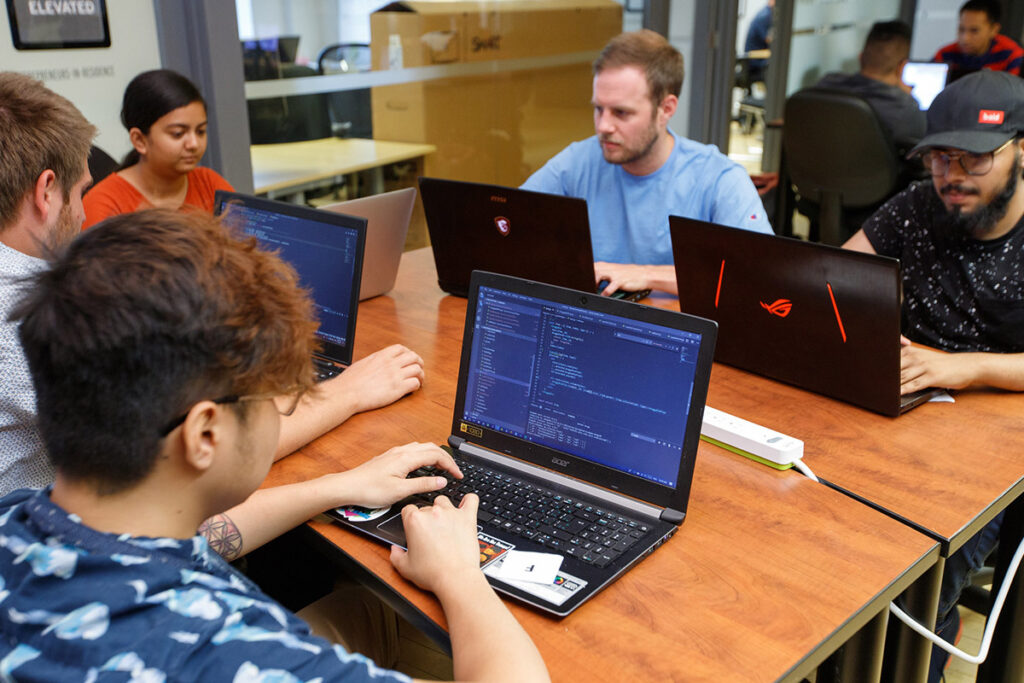 Students working on laptops in a classroom