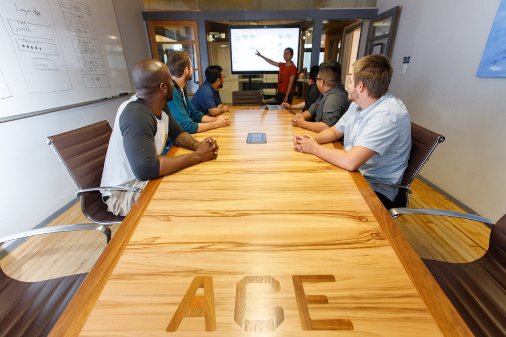 Instructor giving presentation to students in a boardroom