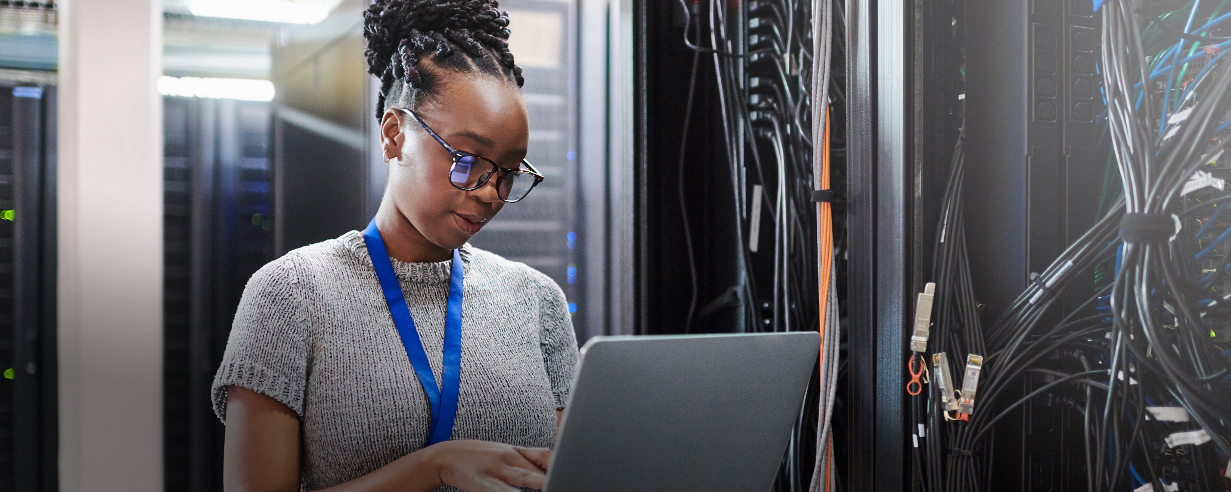 Woman on a laptop in a data centre