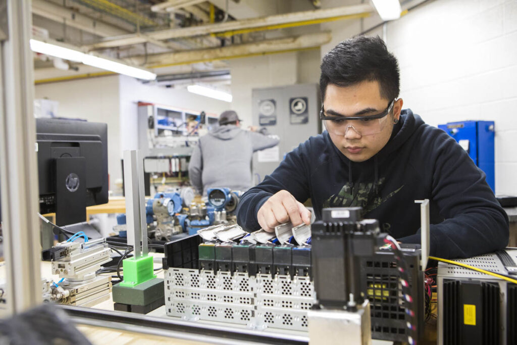 Student in a lab working with some electronic controls