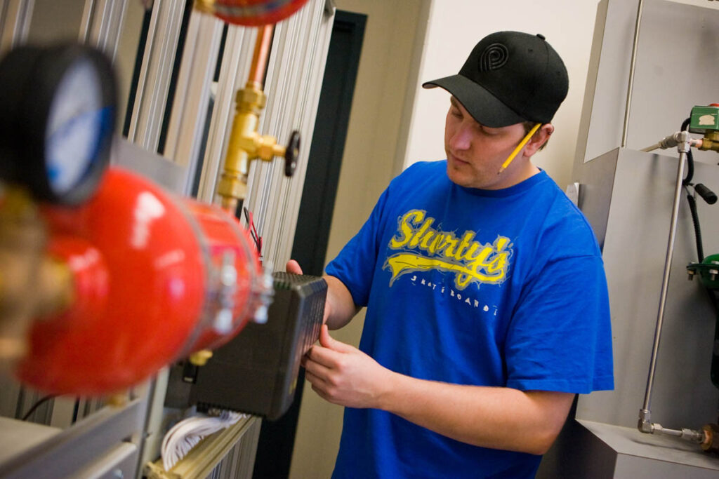 Student in a lab working on a control panel