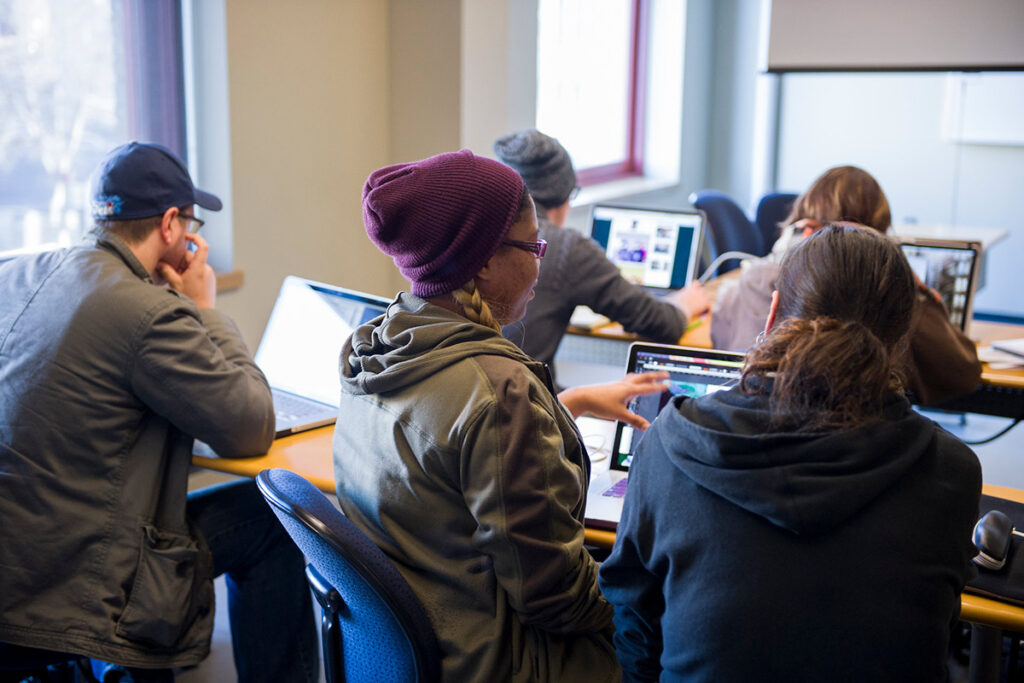 Students with laptops sitting in a classroom