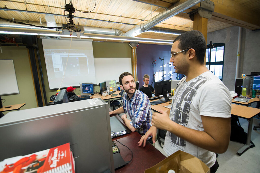 Instructor talking to student in a classroom