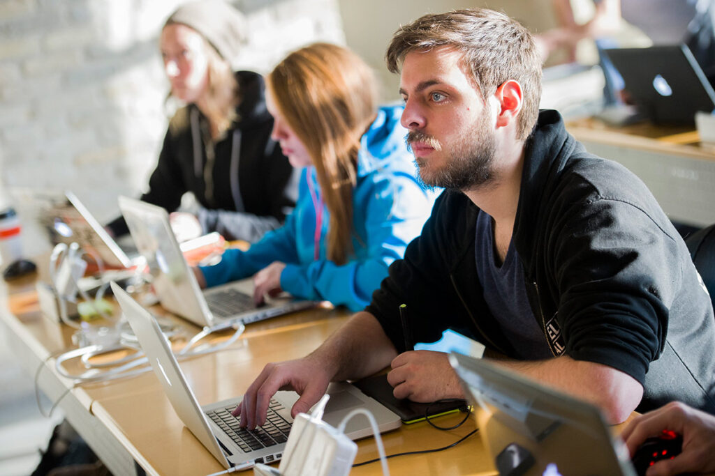 Students on their laptops in a classroom