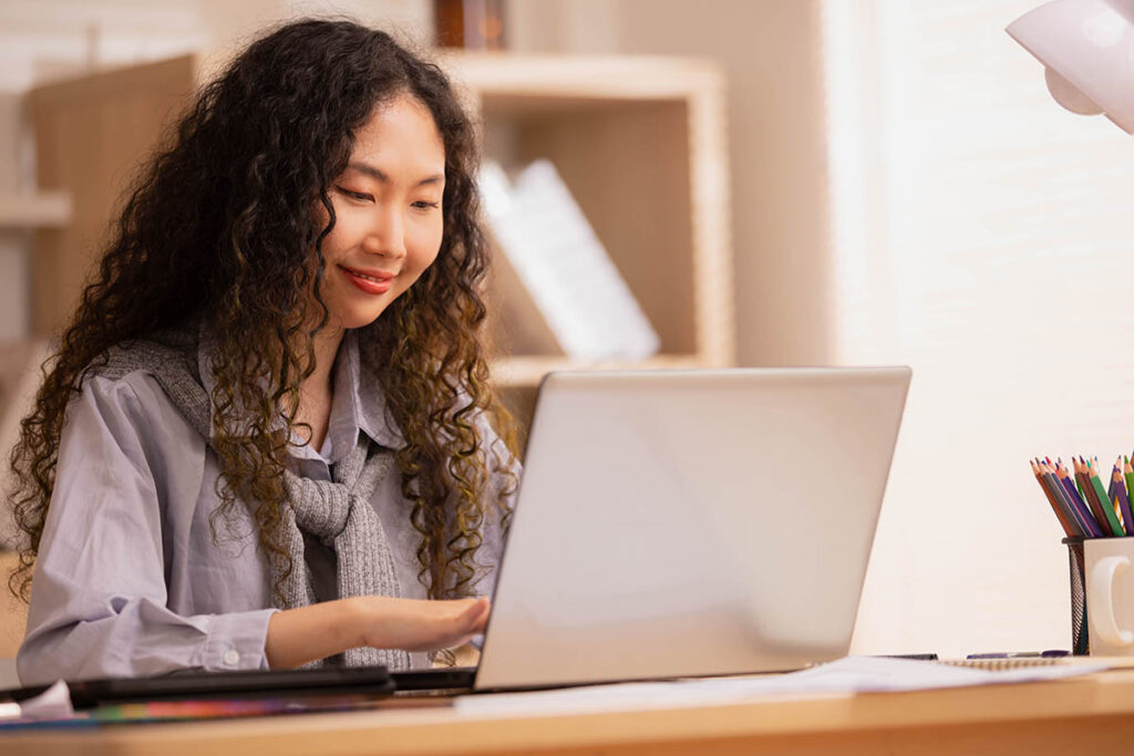 Smiling woman working on a laptop