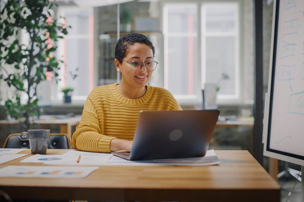 Woman working on a laptop in an office environment