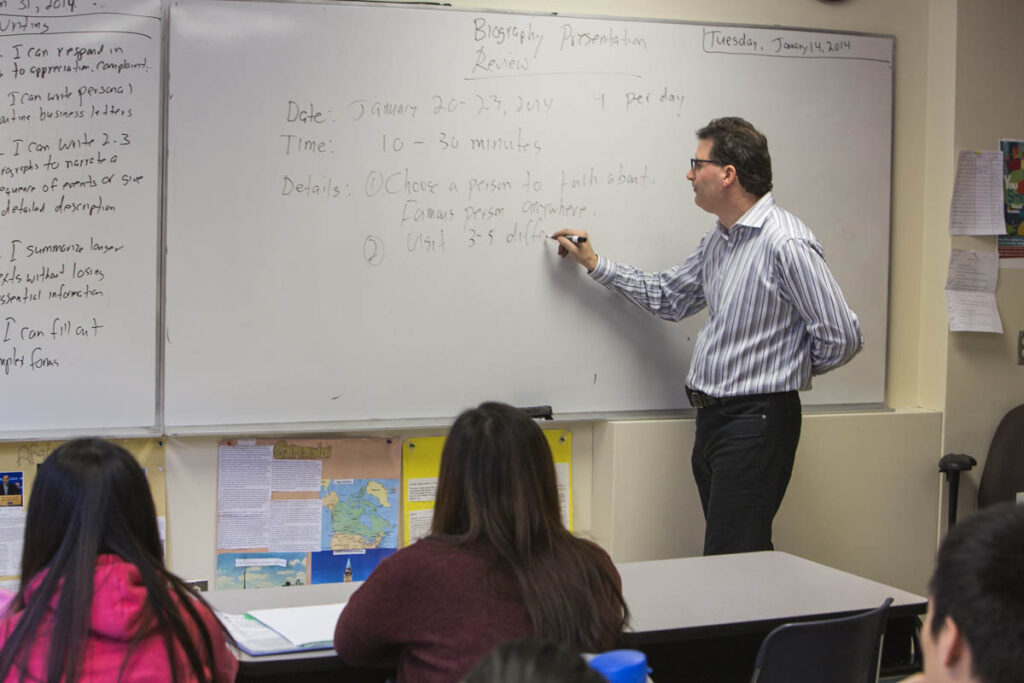 Instructor talking to a class full of students