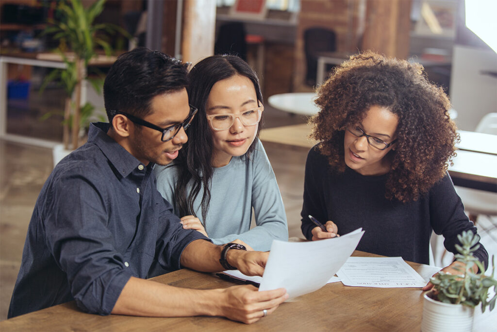 Students gathered around a table looking at notes
