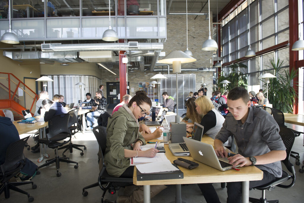 Open workspace filled with students on laptops