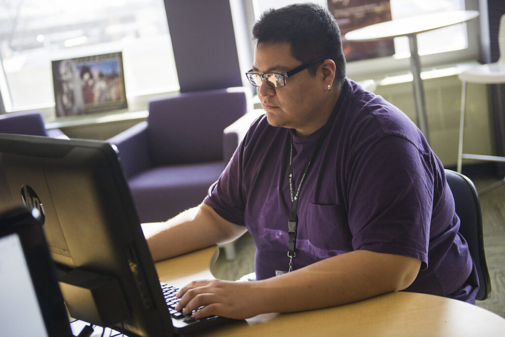 Person in a classroom working on a computer