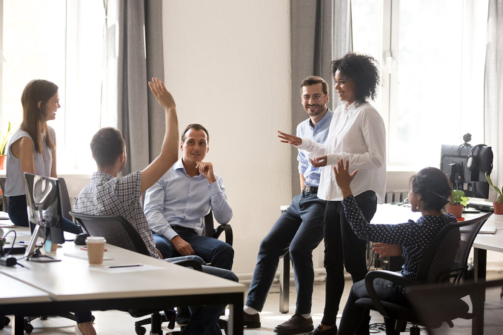 Colleagues talking to each other in an office