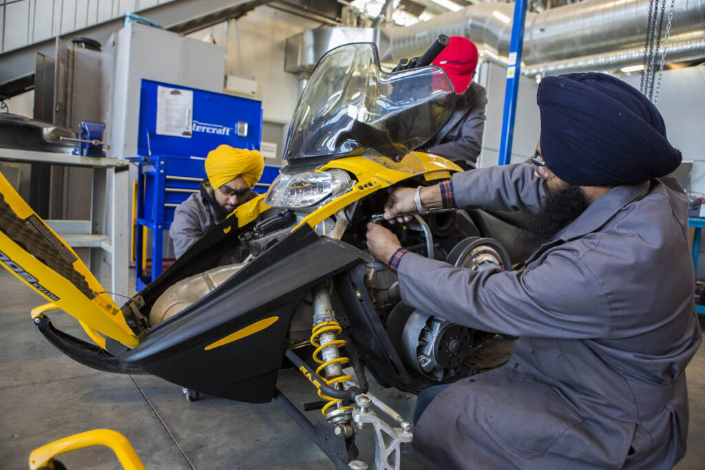 Mechanics inspecting a jetski