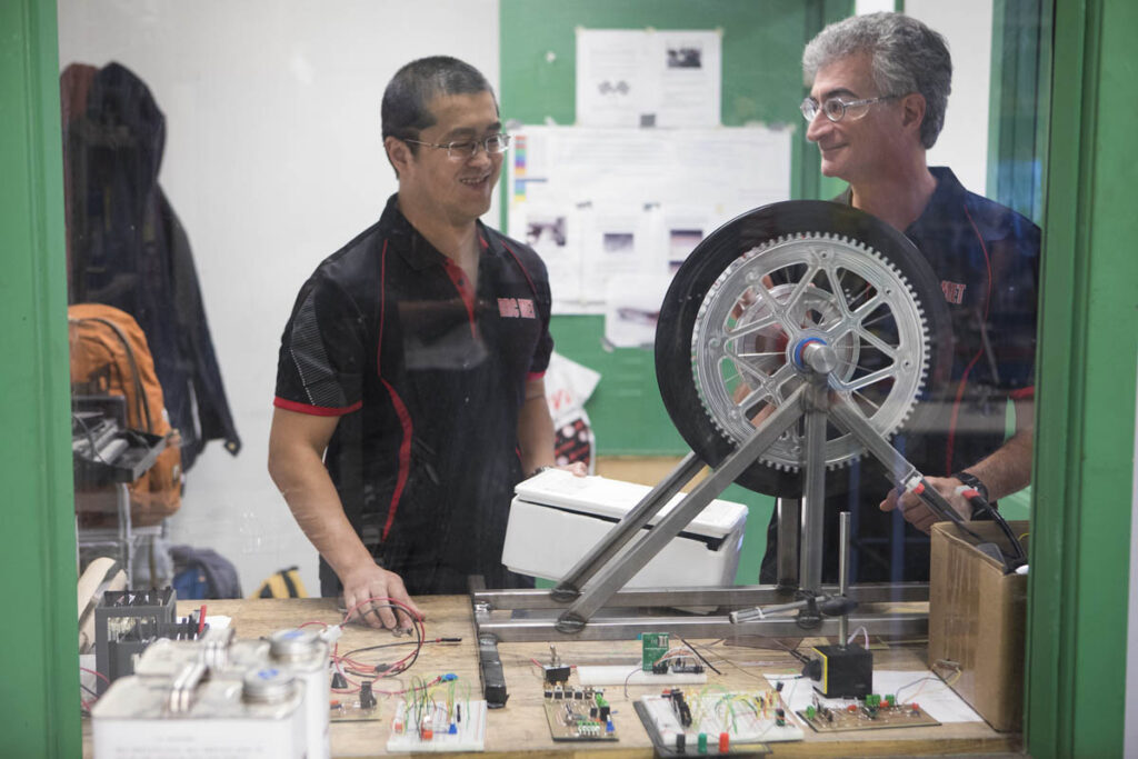 Instructor and student looking at wheel for vehicle