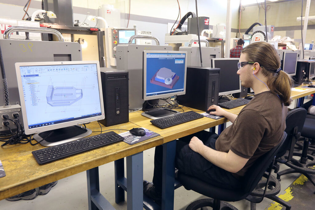 Student using CAD software to draw a 3D object