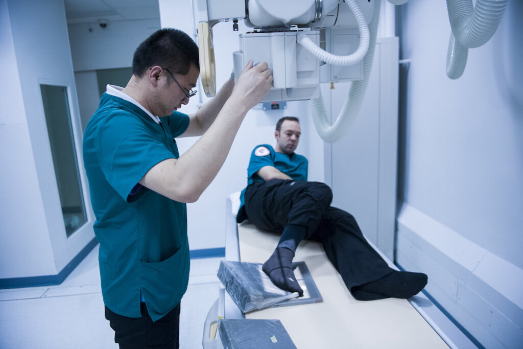 Students learning how to use medical equipment