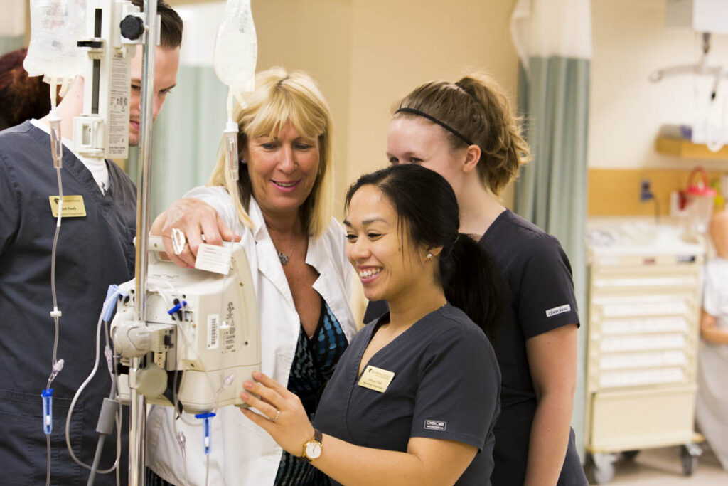 Nursing students learning how to use IV machine