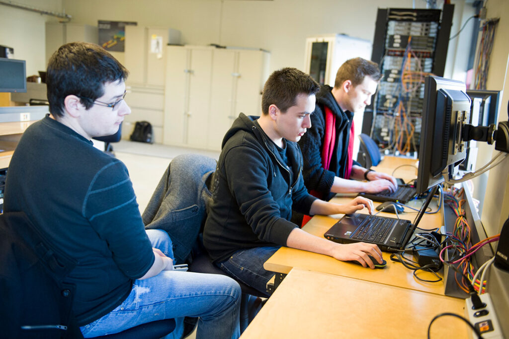Students in a networking lab working on a computer