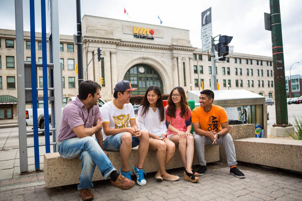 Students sitting on a bench in downtown Winnipeg