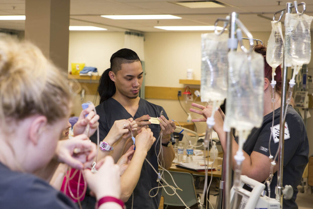 Nursing students learning how to use IV bags